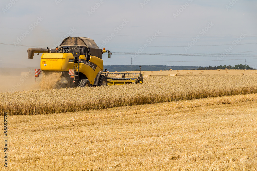 yellow combine harvester working in wheat field
yellow combine harvester working in wheat field