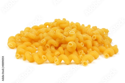Pile of uncooked dry cavatappi pasta isolated on a white background