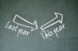 last year and this year arrow on blackboard