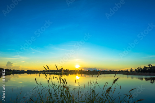 Sunset landscape with blue sky at the calm lake