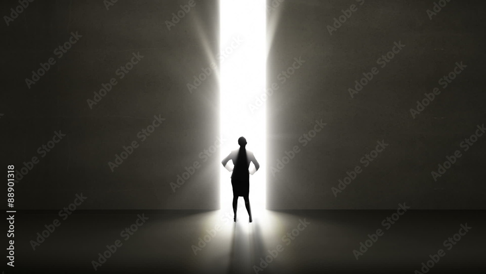 Businesswoman looking at light shining through opening Businesswoman looking at light shining through opening