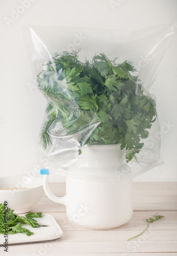 properly stored fresh herbs - in water and wrapped in plastic