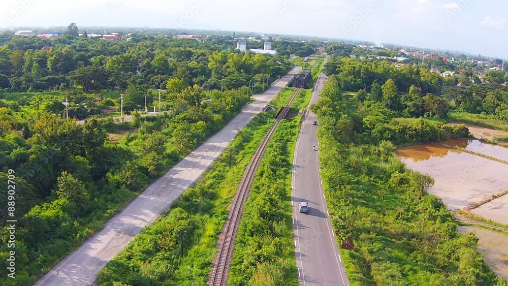 Aerial shot view railway with road on green filed Aerial shot view railway with road on green filed