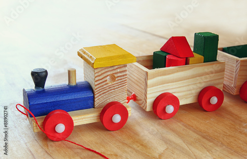 close up of Wooden toy train over wooden table. selective focus.