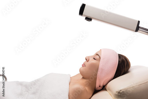 Beauty treatment of face skin with ozone facial steamer in spa center , asian women facing the steam. Steam for smooth skin, isolated on white with clipping path