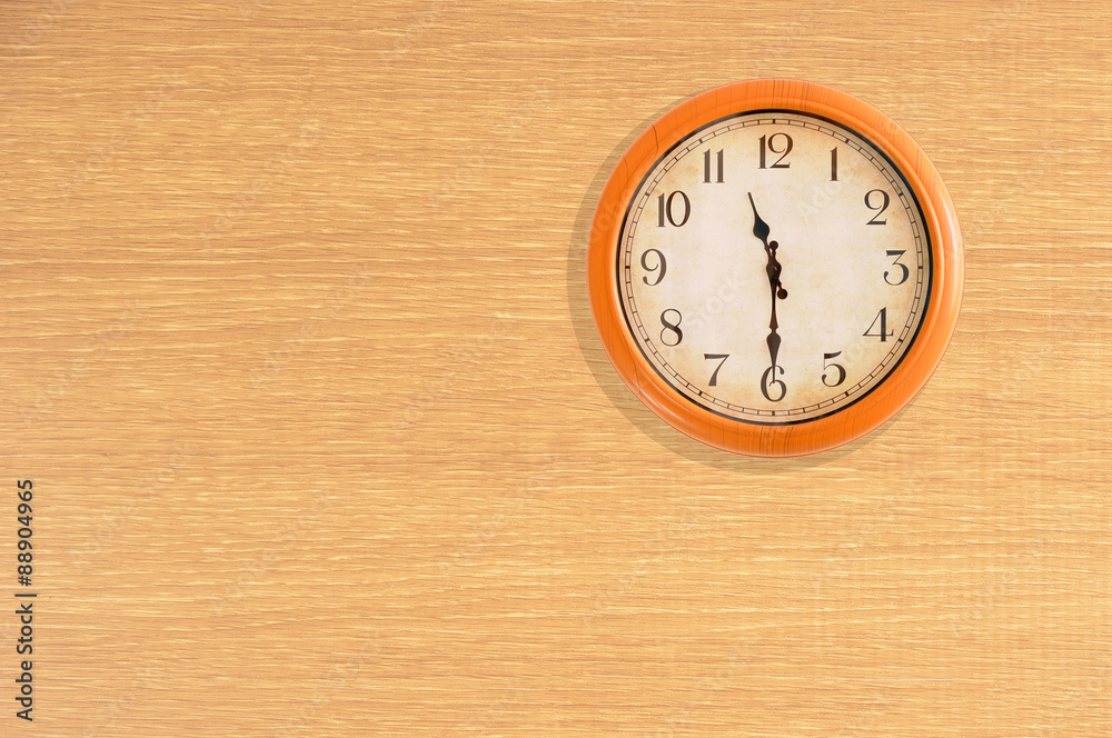 Clock showing 11:30 o'clock on a wooden wall Clock showing 11:30 o'clock on a wooden wall