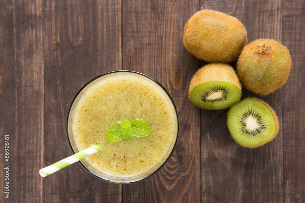 kiwi smoothie with fresh fruits on wooden background. Top view kiwi smoothie with fresh fruits on wooden background. Top view