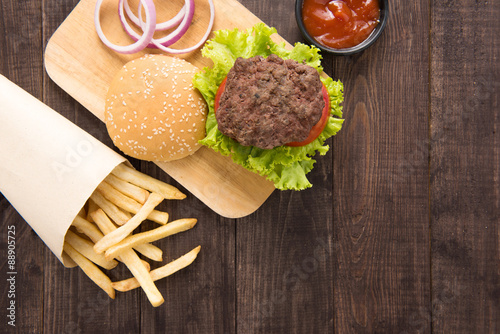 hamburger with french fries on wooden background