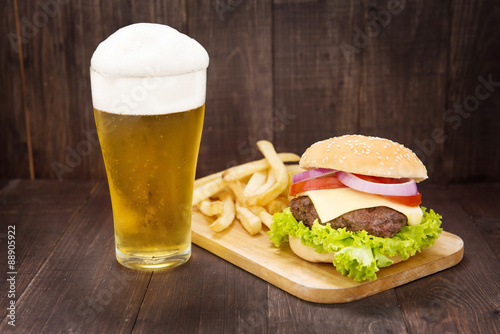 Hamburgers with beer on the wooden table