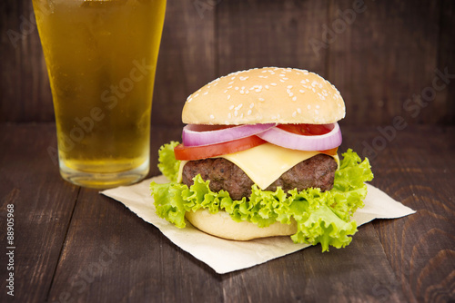 Hamburgers with beer on the wooden table