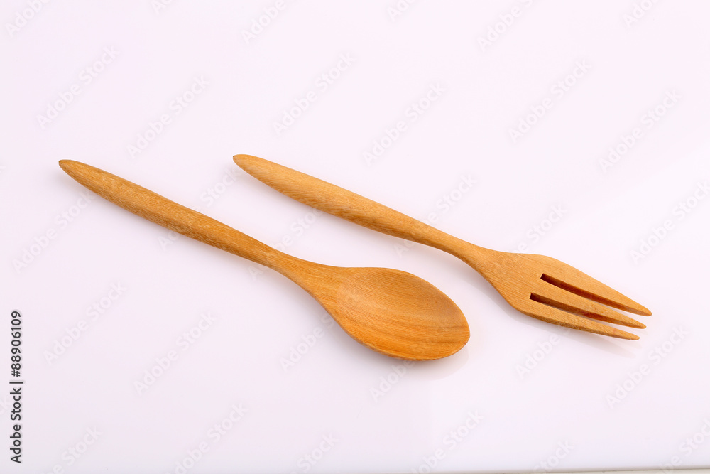 Wooden fork and wooden spoon made by Teak isolated on white back Wooden fork and wooden spoon made by Teak isolated on white back