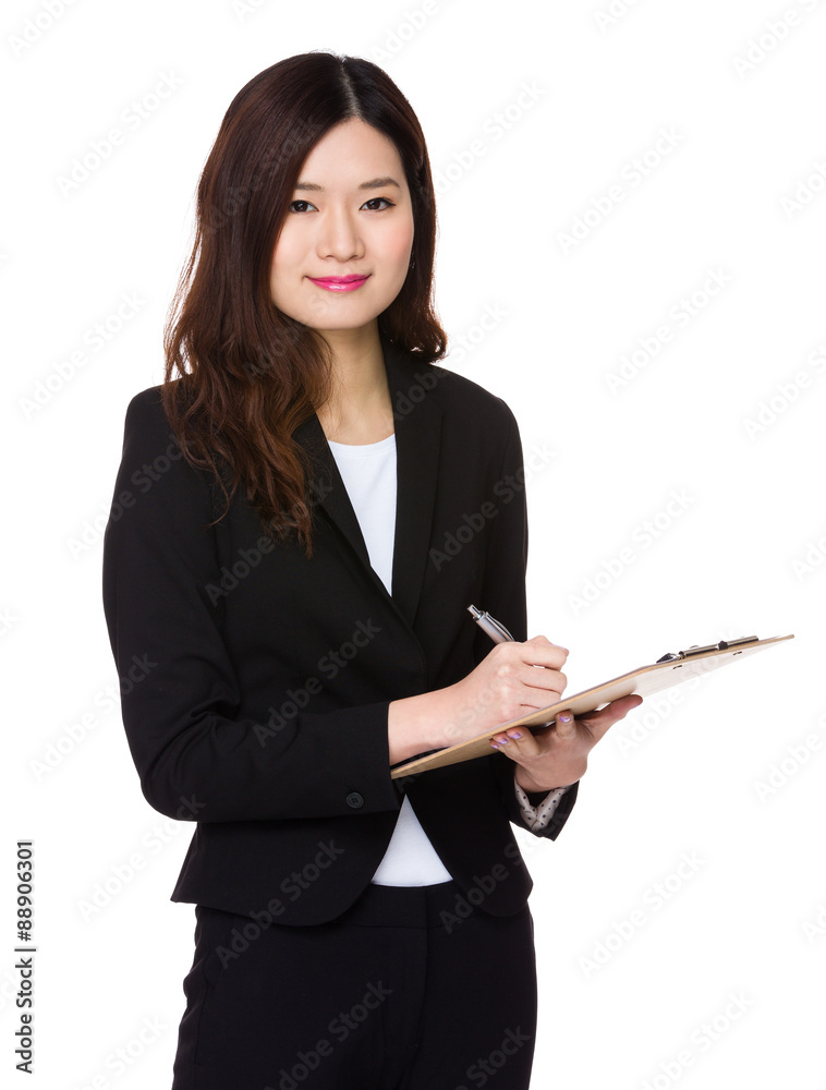 Businesswoman take note on clipboard Businesswoman take note on clipboard