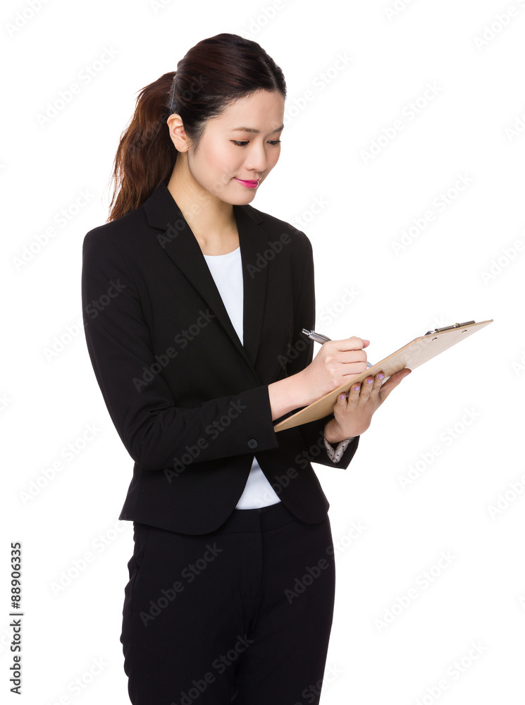 Asian Young businesswoman take note on clipboard Asian Young businesswoman take note on clipboard