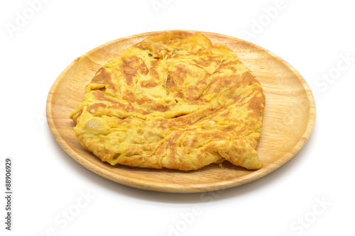 Isolated close up omelet on wooden dish