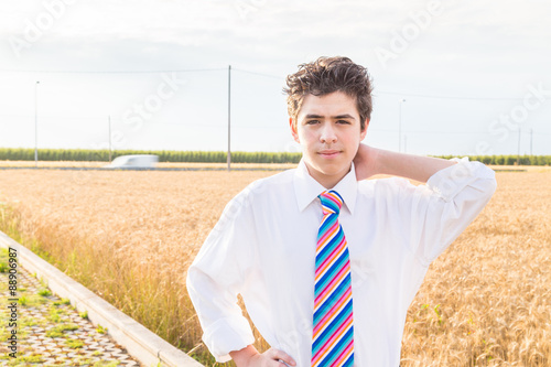 Handsome boy in a golden wheat field