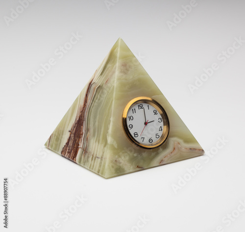 vintage onyx watch in the shape of a pyramid on gray background