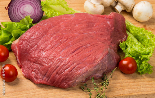 pice of fresh raw meat with vegetables