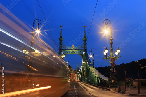 The green Freedom Bridge, with yellow tram, in Budapest,the capital of Hungary