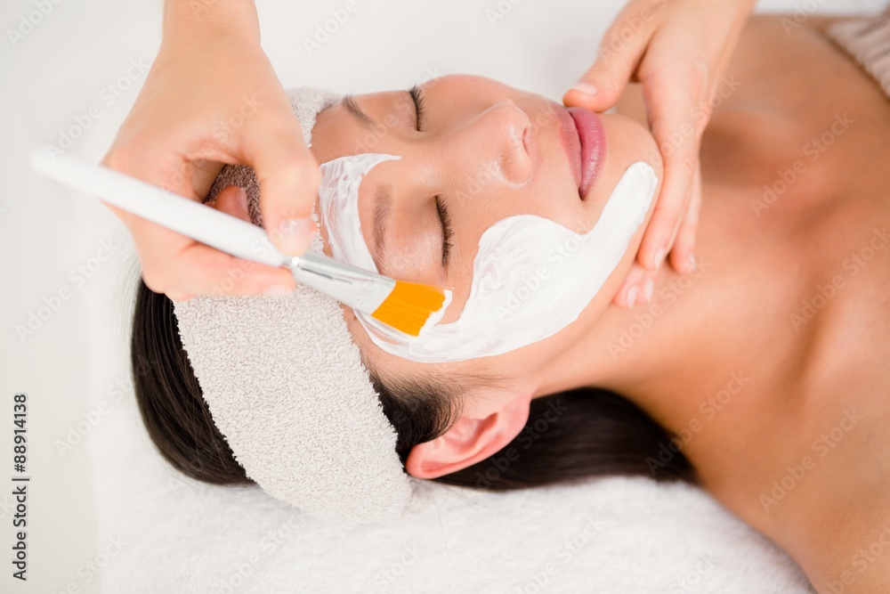 Naklejka premium Attractive woman receiving treatment at spa center
