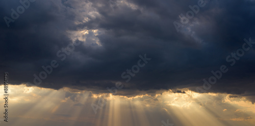 bright sunlight from dark clouds and blue sky