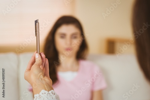 Photography Hypnotherapist holding pen before her patient