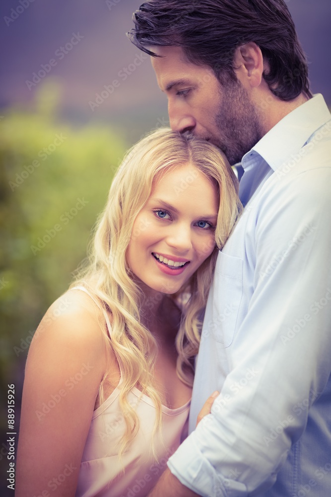 Young happy man kissing woman on the forehead Young happy man kissing woman on the forehead
