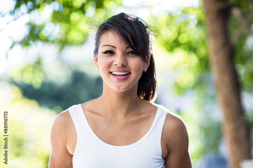 Portrait of smiling athletic woman looking at camera Portrait of smiling athletic woman looking at camera