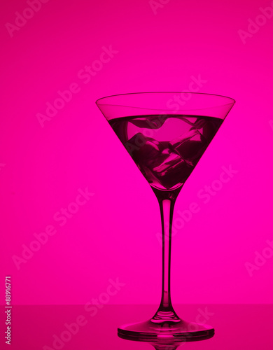 colourful coctail with ice on the pink background
