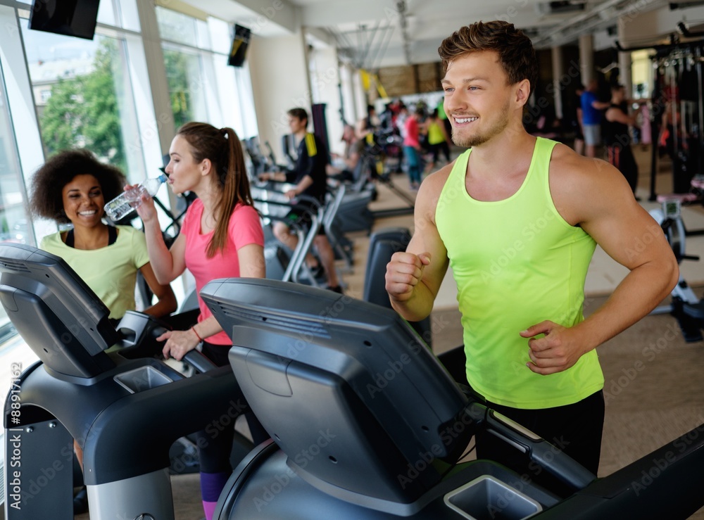 Man running on a treadmill in a gym Man running on a treadmill in a gym