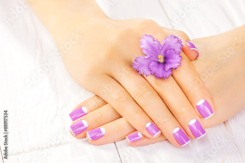 french manicure with violet flowers. spa