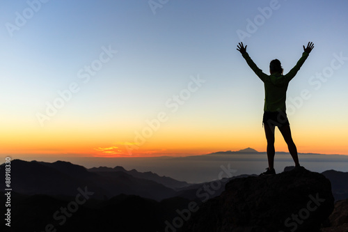 Woman climber success silhouette in mountains  achievement inspi