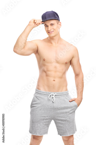 Handsome young man posing with a blue cap