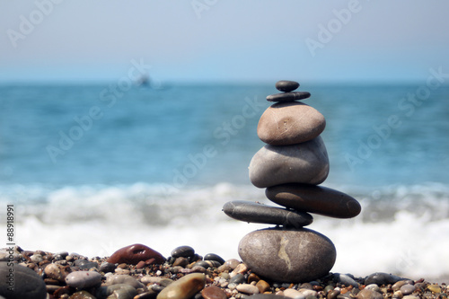 Canvas Print pile of balanced round stones on the beach