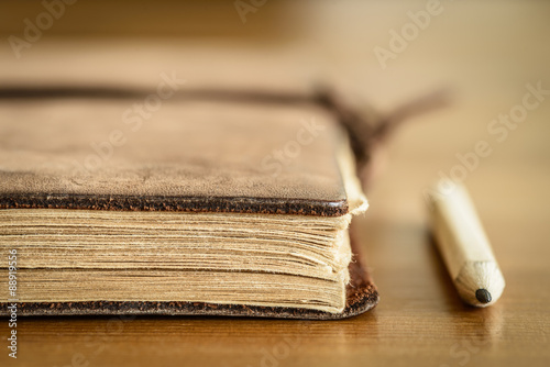 Vintage leather notebook with pencil.