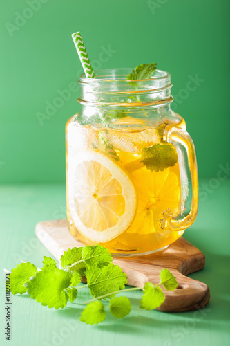 ice tea with lemon and melissa in mason jar