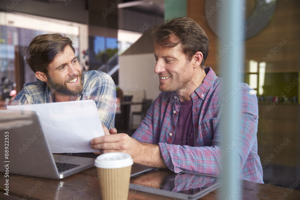 Two Businessmen Working On Laptop In Coffee Shop Two Businessmen Working On Laptop In Coffee Shop
