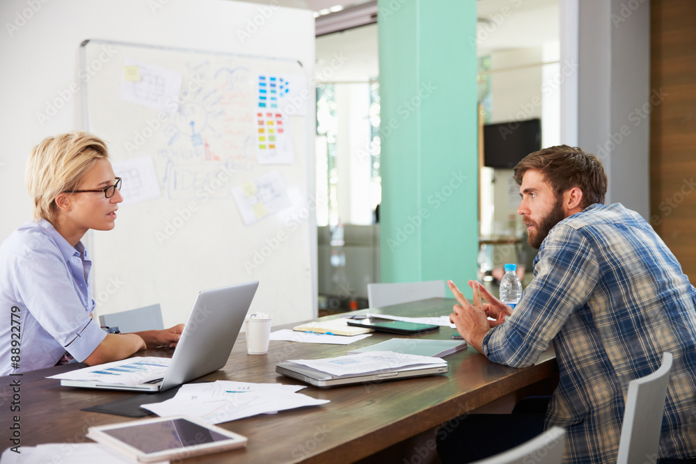 Two Businesspeople Having Creative Meeting In Office Two Businesspeople Having Creative Meeting In Office