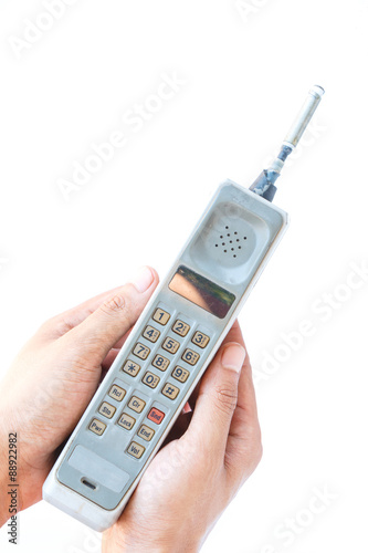 man hand holding vintage mobile phone Isolated on white background.