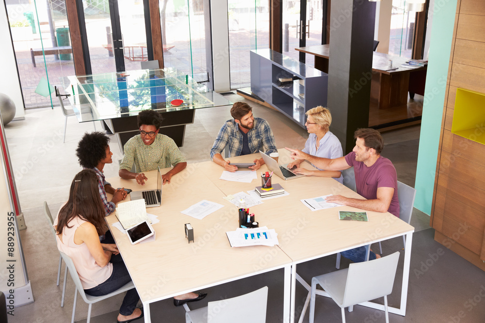 High Angle Of Businesspeople Having Meeting In Modern Office High Angle Of Businesspeople Having Meeting In Modern Office