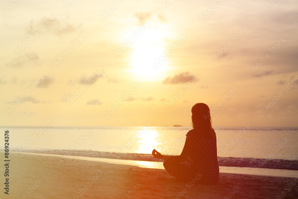 Woman meditation on sunset beach Woman meditation on sunset beach