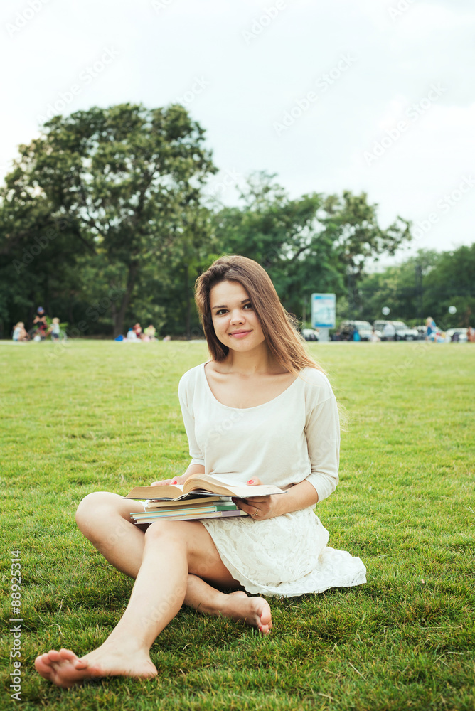 young caucasian female student with books on campus, student study in campus area young caucasian female student with books on campus, student study in campus area