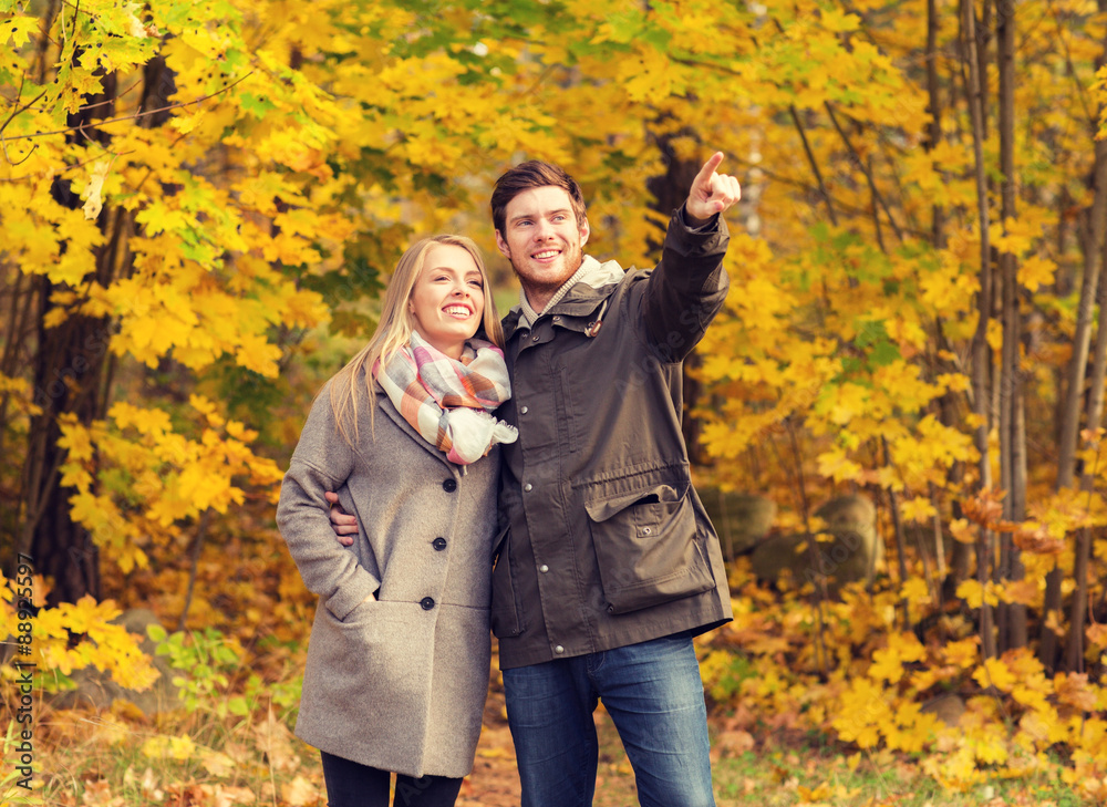 smiling couple hugging in autumn park smiling couple hugging in autumn park