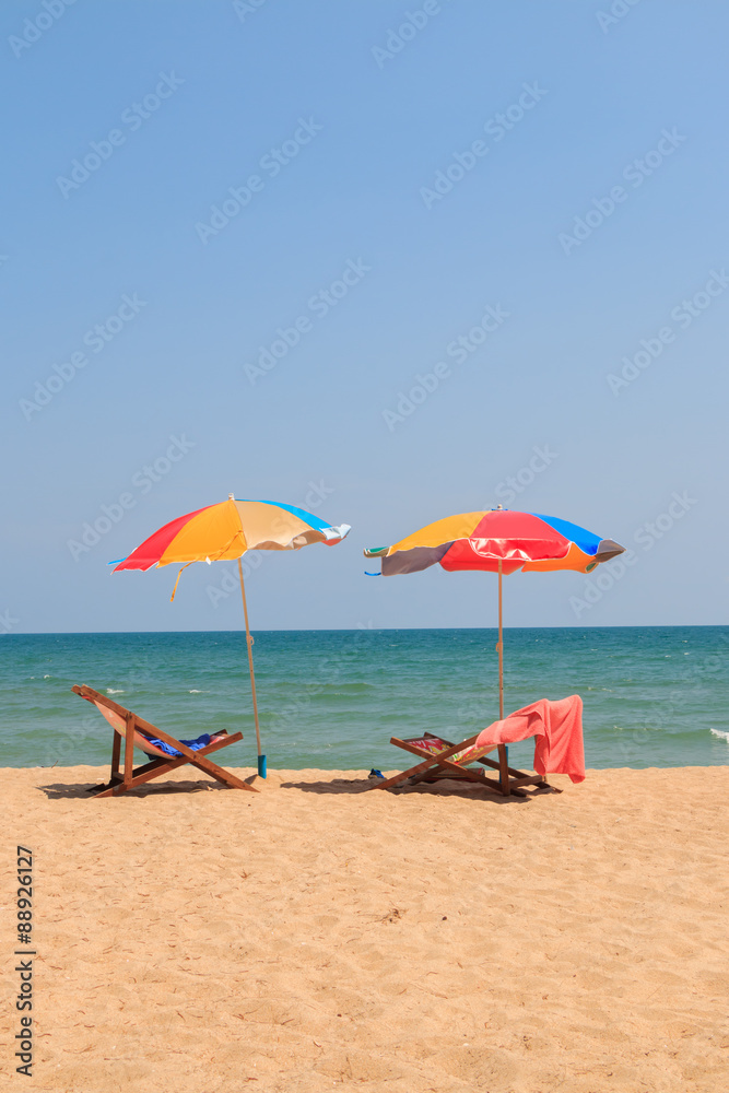 Beach chair and umbrella on sand beach