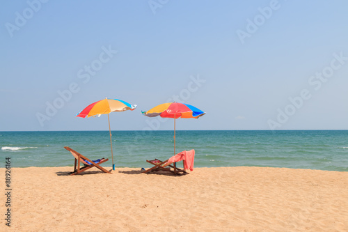 Beach chair and umbrella on sand beach