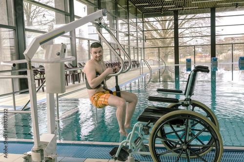 Disabled man in a swimming pool. Wheelchair. Disabled person in a wheelchair.