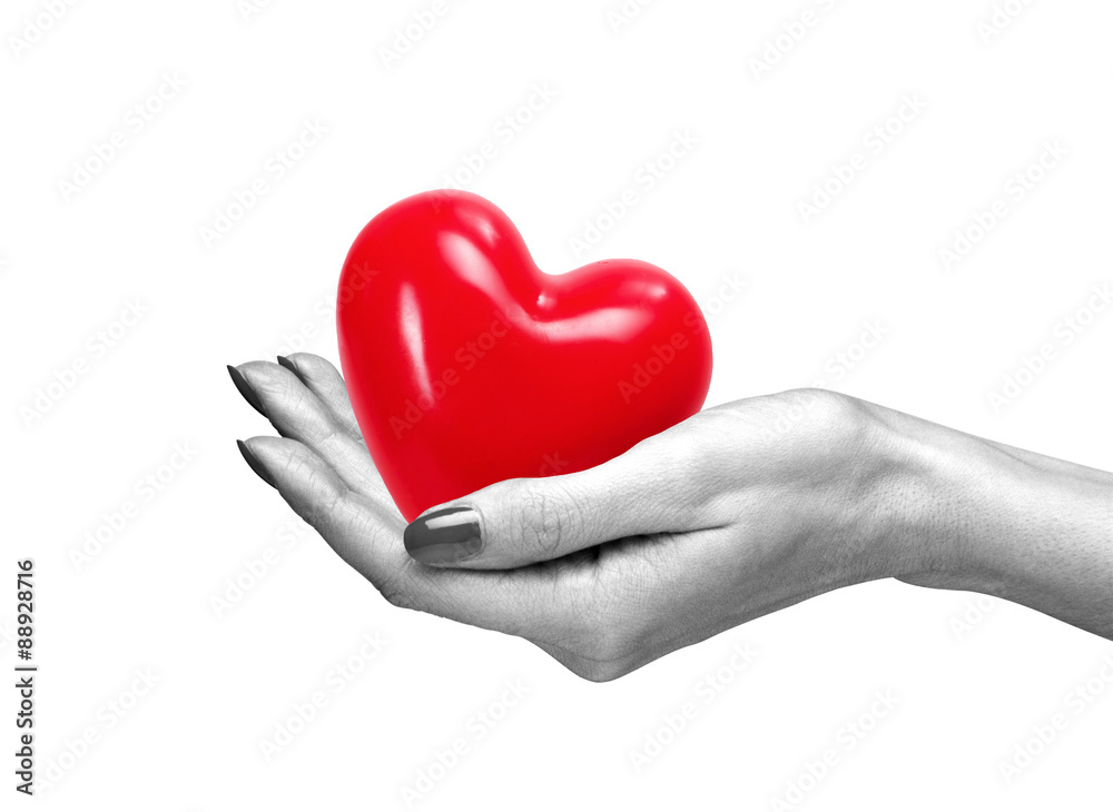 Red heart in woman hand, isolated on white