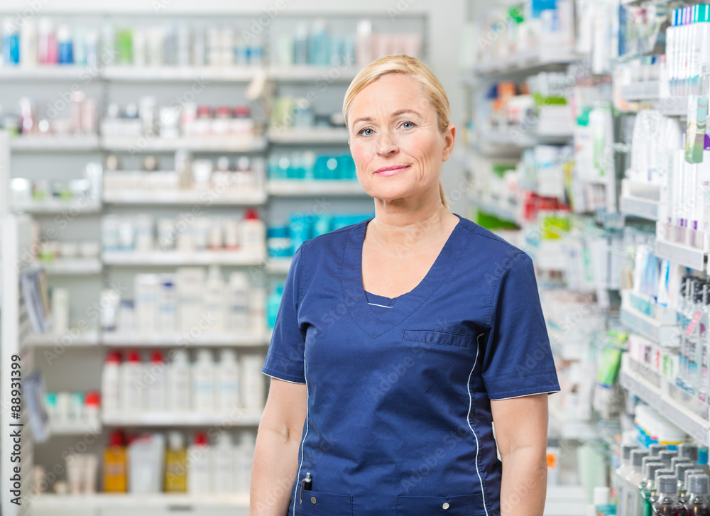 Female Pharmacist In Uniform Standing At Pharmacy