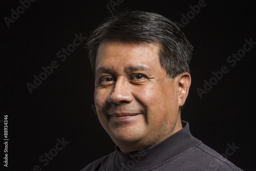 Studio portrait of a smiling Hispanic male