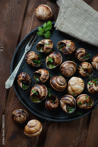 Fototapeta Naklejka Na Ścianę i Meble -  Escargots de Bourgogne in a frying pan, above view, close-up