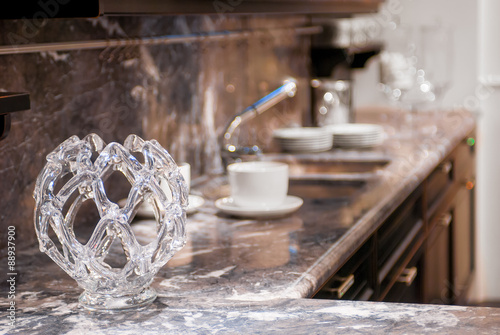beautiful glass vase on the marble worktop in the kitchen